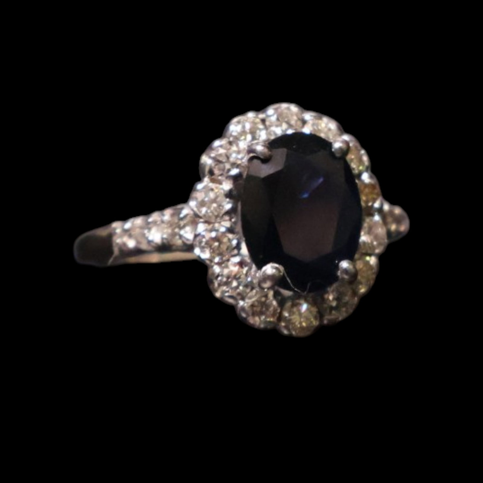 14K Sapphire and Diamond Ring: Date: Late 20th to early 21st century Materials: 14K white gold, sapphire, and diamonds Form: Ring Description: A 14K white gold ring centered by an oval blue sapphire and framed by round diamond