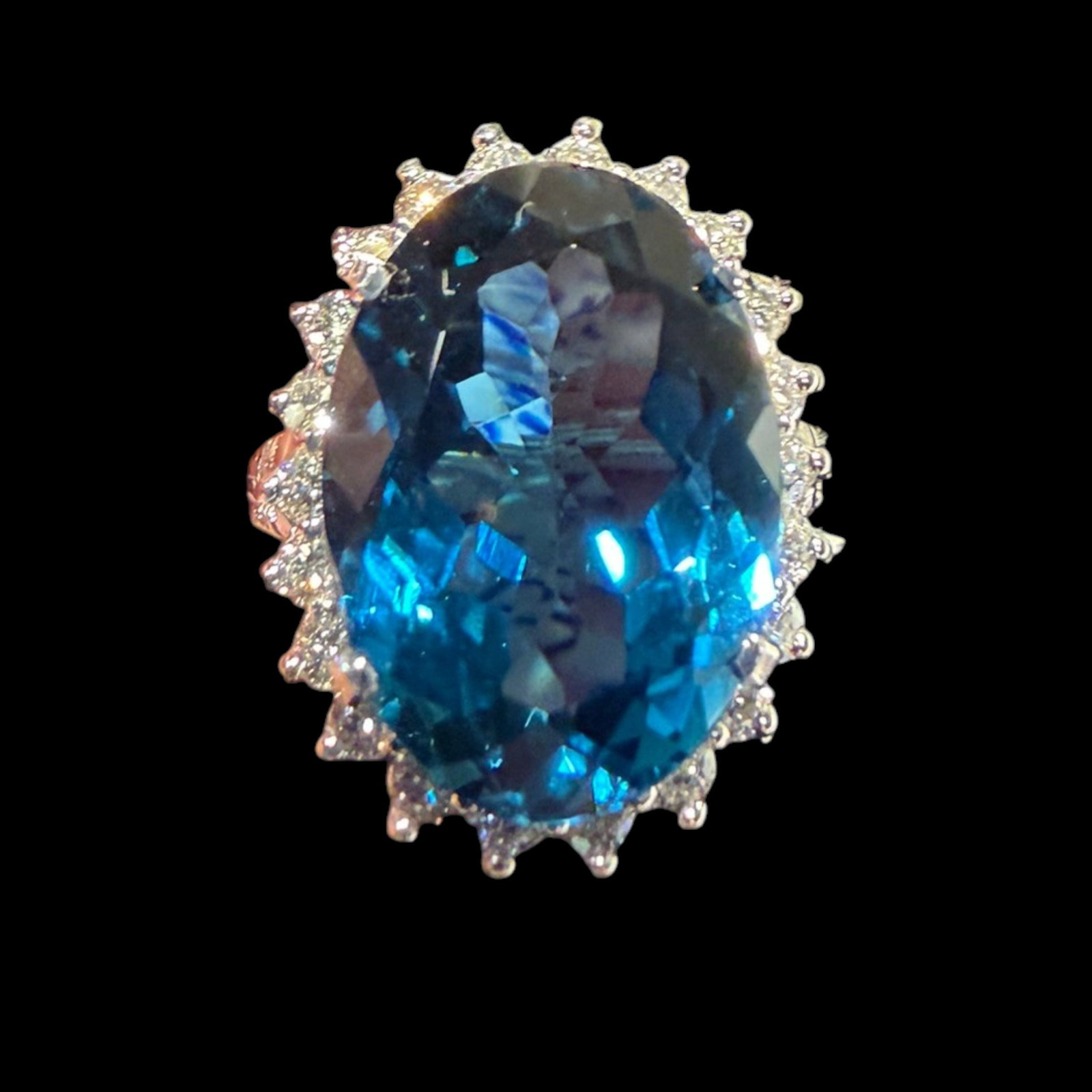 18K London Blue Topaz Diamond Ring: Date: Late 20th to early 21st century Materials: 18K white gold, London blue topaz, and diamonds Form: Cocktail ring Description: An 18K white gold cocktail ring centered by a large London blue topaz