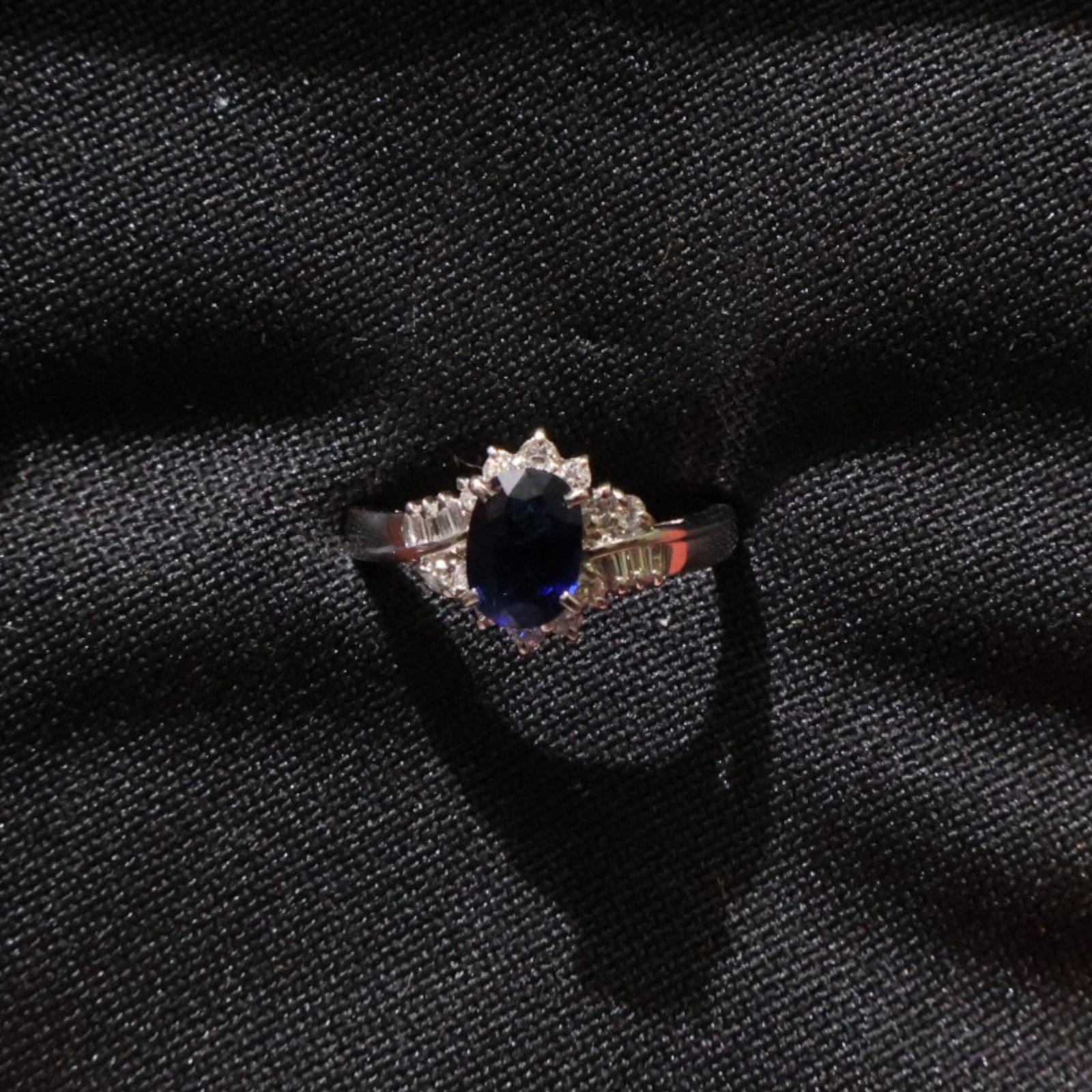 Platinum Sapphire and Diamond Ring: Date: Late 20th to early 21st century Materials: Platinum, sapphire, and diamonds Form: Ring Description: A platinum ring centered by a blue sapphire and accented by diamonds along the setting and
