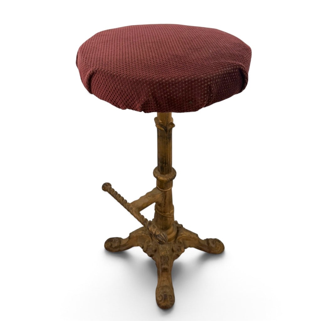 Antique Adjustable Cast-Iron Bar Stool: Origin: American, probably Date: Circa 1900-1925 Period/Style: Victorian Revival / Industrial Maker: Unidentified Materials: Cast iron, upholstery, and fabric Form: Adjustable swivel bar stool