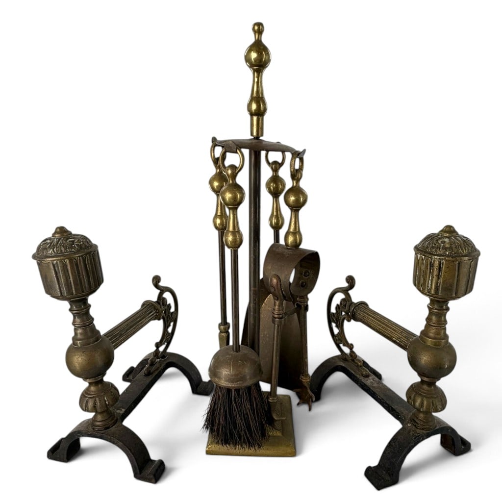 Brass Andirons and Fireplace Tool Set: Origin: Probably American Date: Early 20th century Period/Style: Colonial Revival Maker: Unmarked Materials: Brass and iron Form: Pair of andirons with four-piece tool set and stand Description: