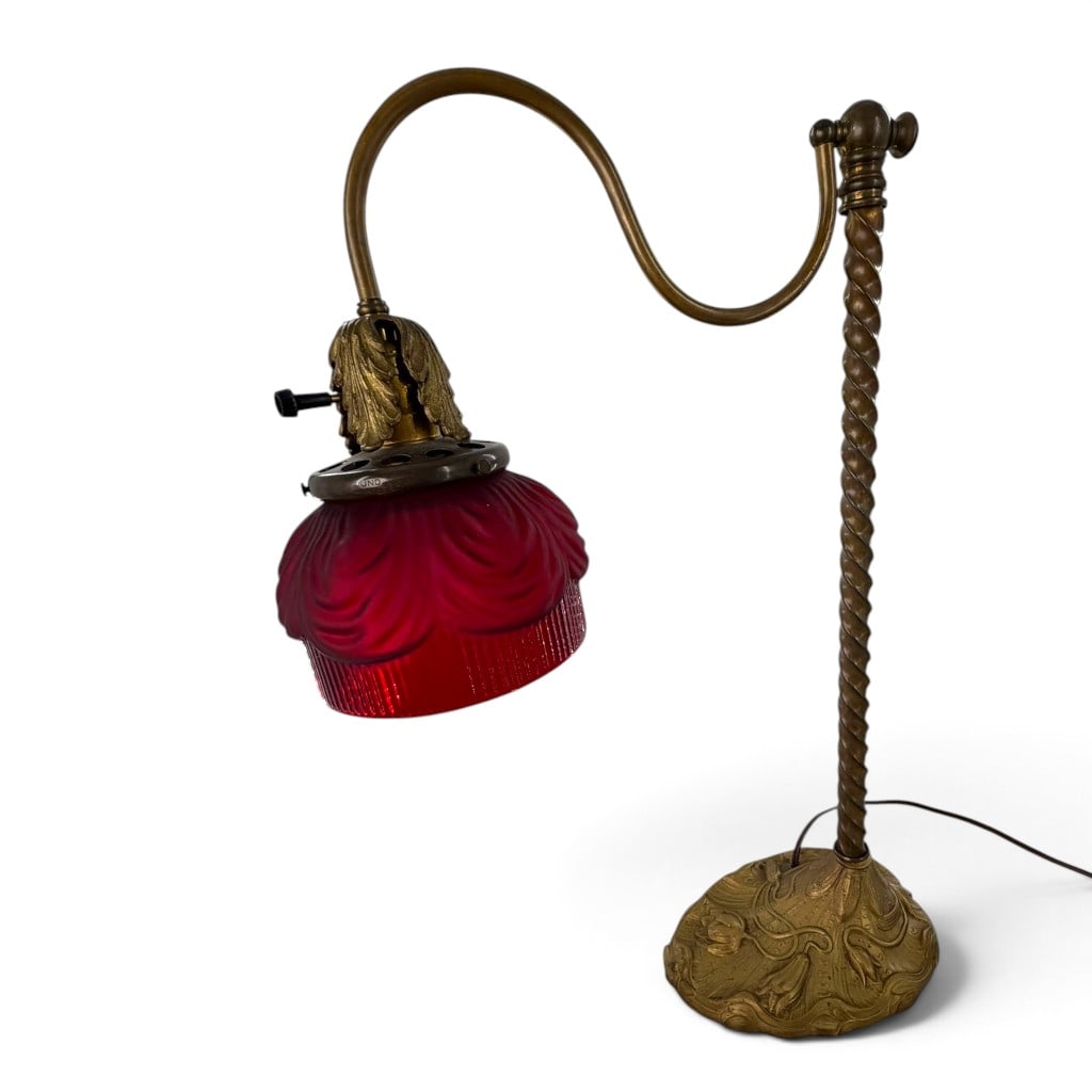 Art Nouveau UNO Lamp with Cranberry Shade: Origin: American Date: Circa 1912-1920 Period/Style: Art Nouveau Maker: Unidentified Materials: Brass, cranberry glass, and electrical fittings Form: Bridge-arm table lamp Description: Art Nouveau