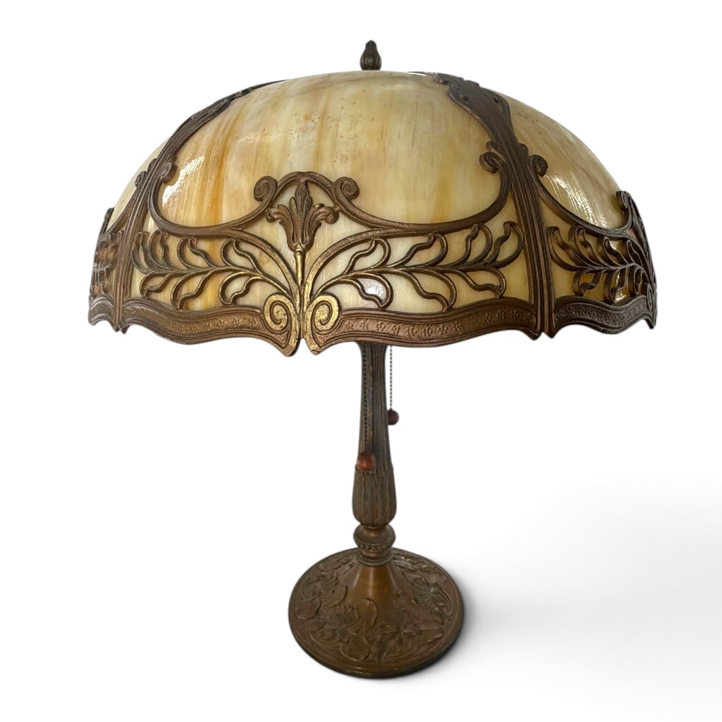 American Art Nouveau Slag Glass Lamp: Origin: Probably American Date: Circa 1910-1925 Period/Style: Art Nouveau and Arts and Crafts Maker: Unmarked Materials: Cream and amber slag glass, patinated cast metal, and brass electrical
