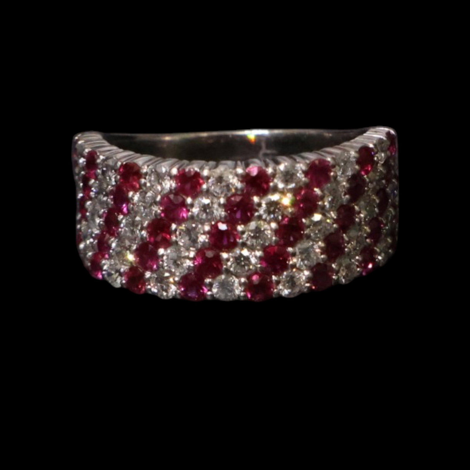 Platinum Ruby and Diamond Ring: Date: Late 20th to early 21st century Materials: Platinum, rubies, and diamonds Form: Ring Description: A platinum ring set with multiple rubies in a geometric arrangement accented by diamonds. The