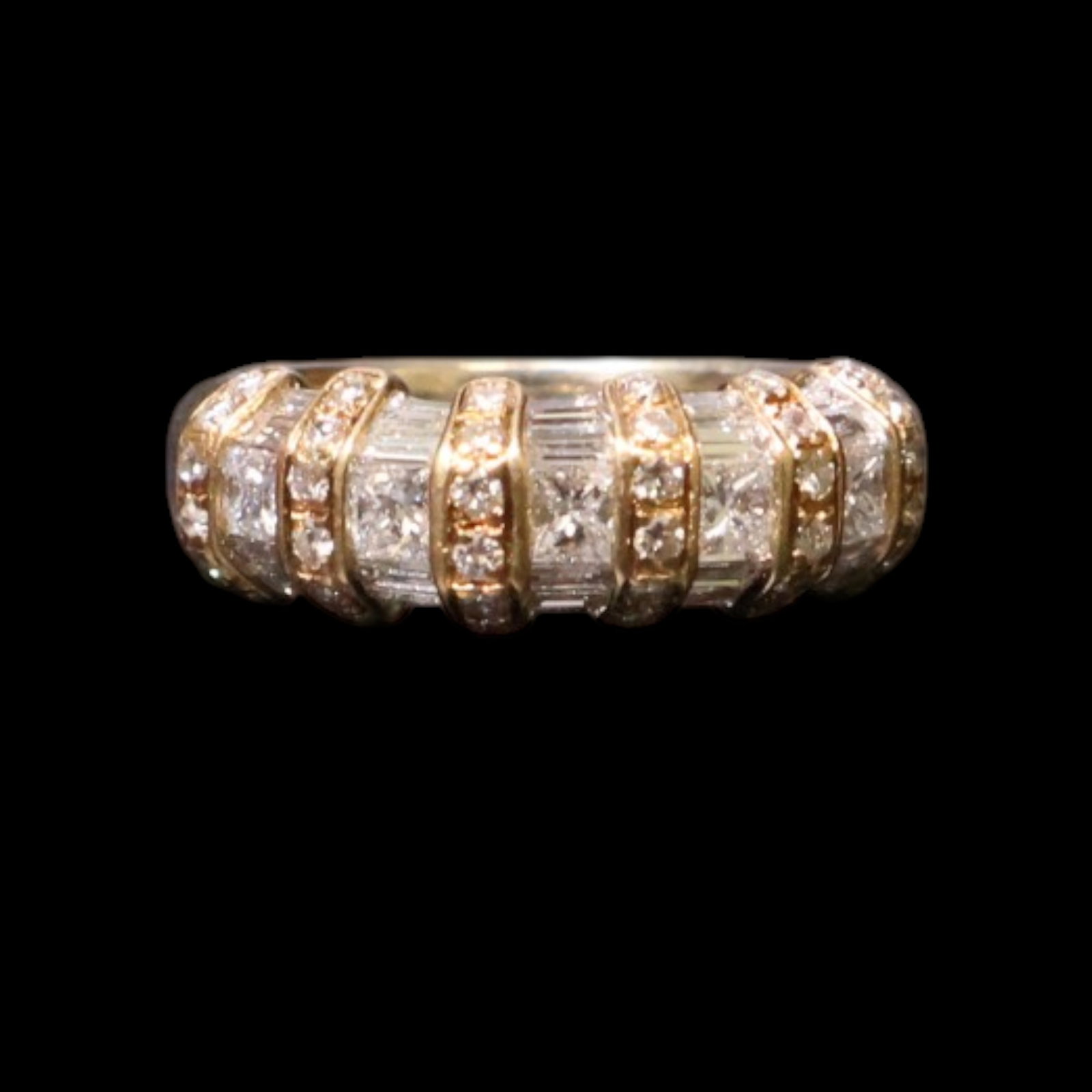 14K Yellow Gold Diamond Ring: Date: Late 20th to early 21st century Materials: 14K yellow gold and diamonds Form: Ring Description: A 14K yellow gold ring set with diamonds across a raised central setting and shoulders.