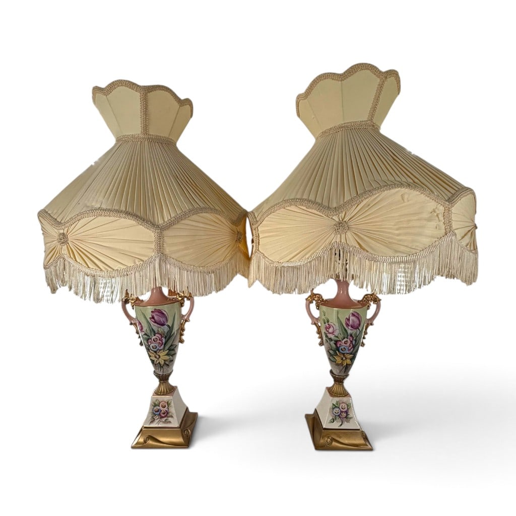 Pair Capodimonte-Style Porcelain Urn Lamps: Date: Mid to late 20th century Origin: Italian Materials: Hand-painted porcelain, gilt decoration, metal, and fabric shades Form: Pair of urn-form table lamps Description: A large matched pair of