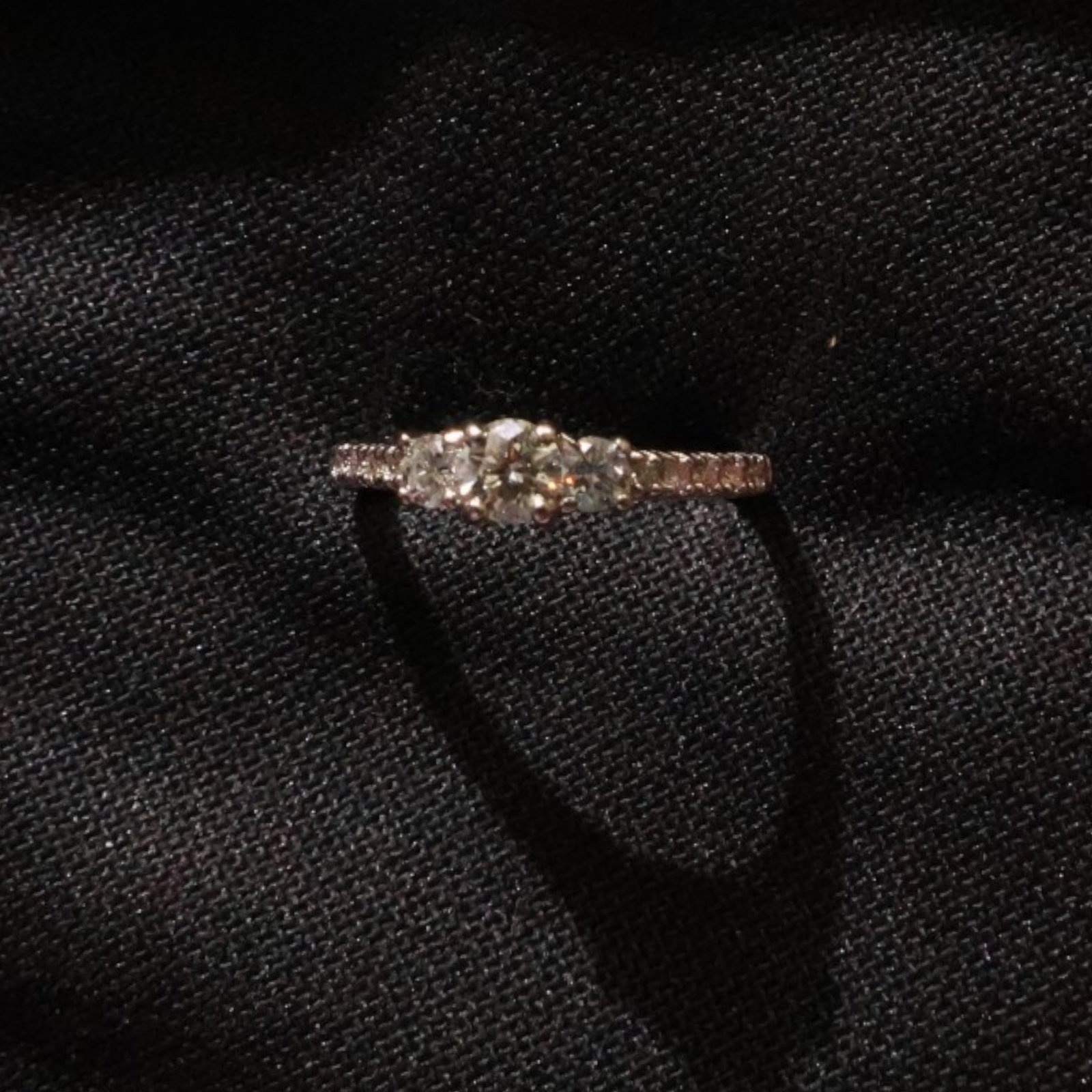 14K Three-Stone Diamond Ring: Date: Late 20th to early 21st century Materials: 14K white gold and diamonds Form: Three-stone ring Description: A 14K white gold ring set with three principal diamonds in a raised linear setting. The