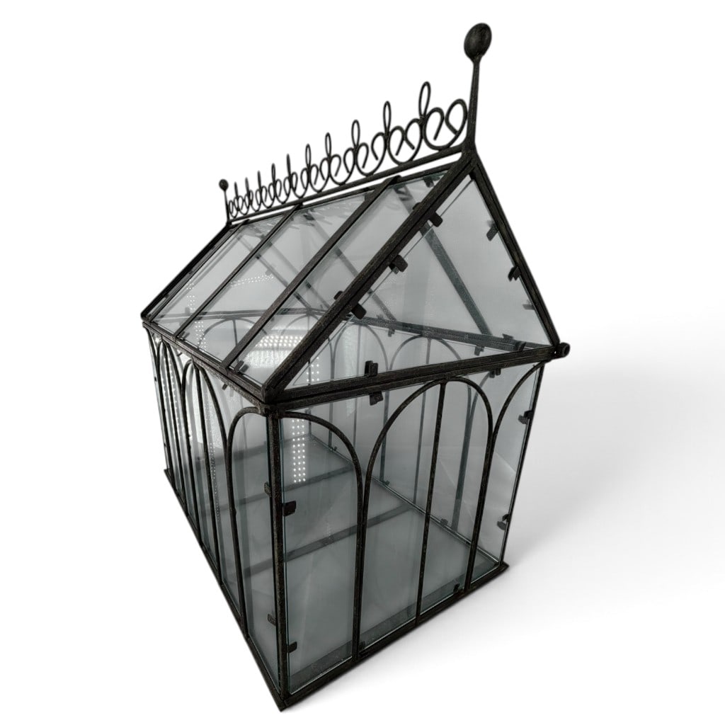 Architectural Greenhouse Terrarium: Origin: Unidentified Date: Late 20th or early 21st century Period/Style: Victorian Revival Materials: Glass and blackened metal Form: Greenhouse-form terrarium Description: Architectural terrarium or