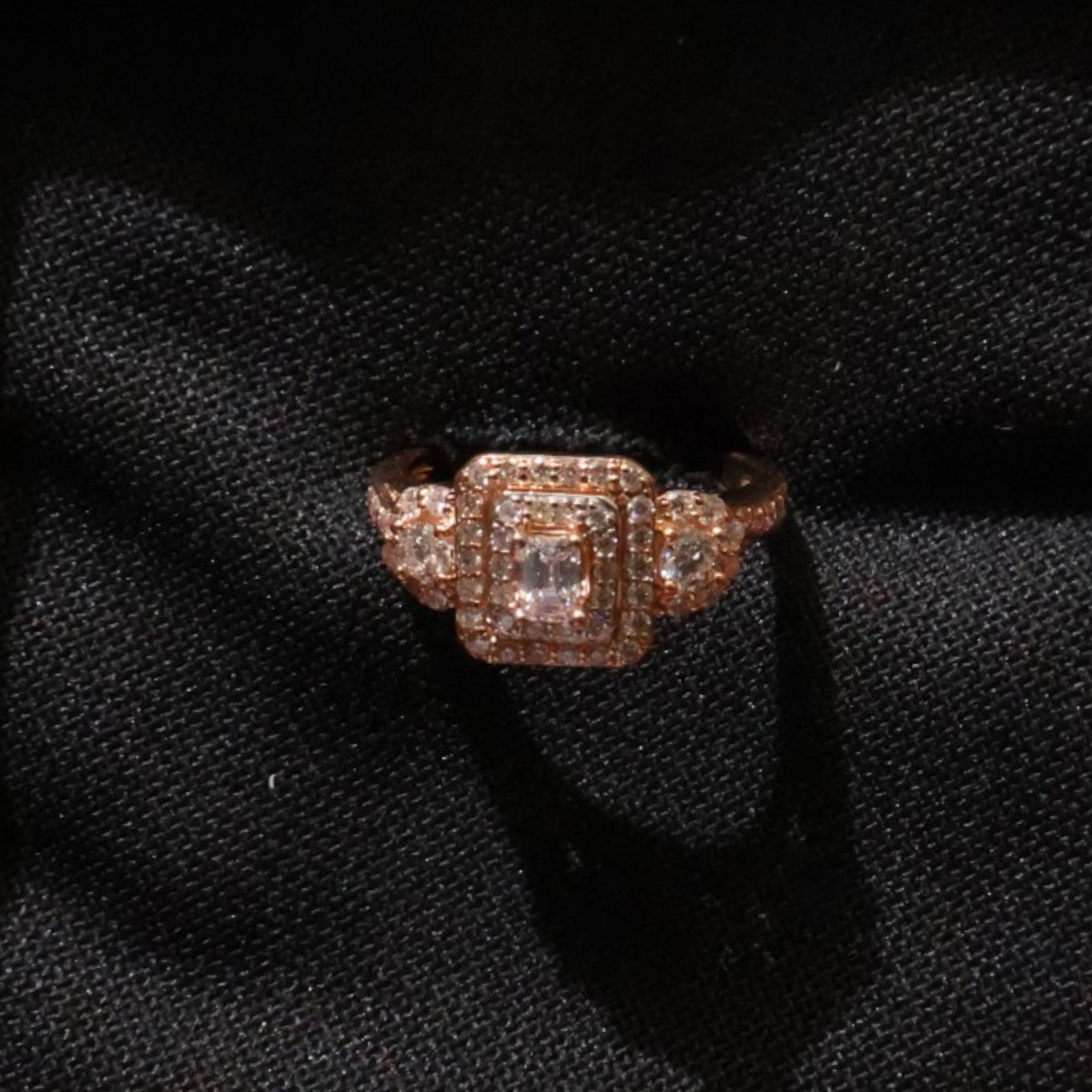 14K Rose Gold Emerald-Cut Diamond Ring: Date: Late 20th to early 21st century Materials: 14K rose gold and diamonds Form: Ring Description: A 14K rose gold ring centered by an emerald-cut diamond with diamond accents along the setting and s