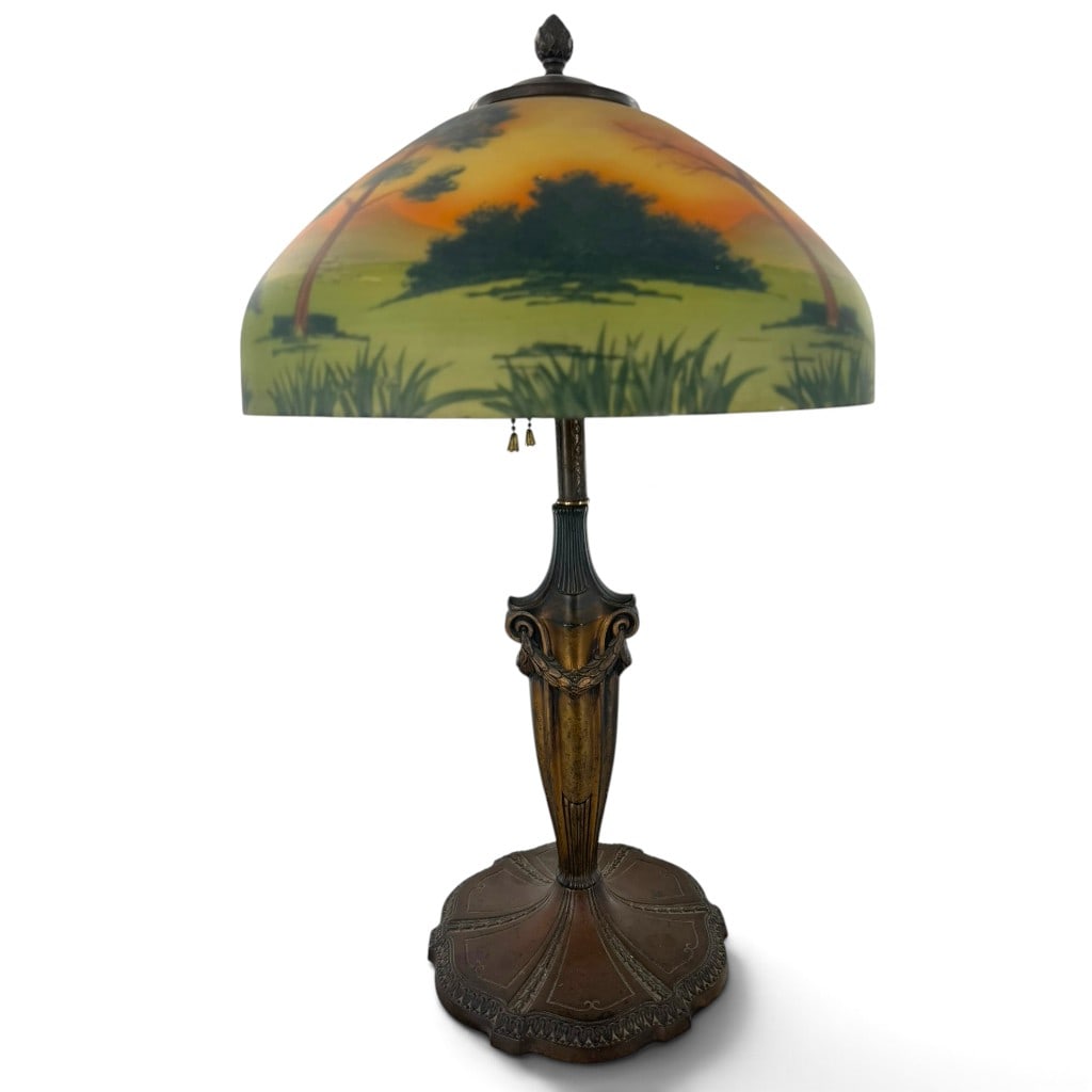 Art Deco Reverse-Painted Lake Scene Lamp: Origin: American Date: Circa 1920 Period/Style: Arts and Crafts / Art Deco Maker: Unattributed American manufacture Materials: Reverse-painted glass and cast metal Form: Two-light table lamp