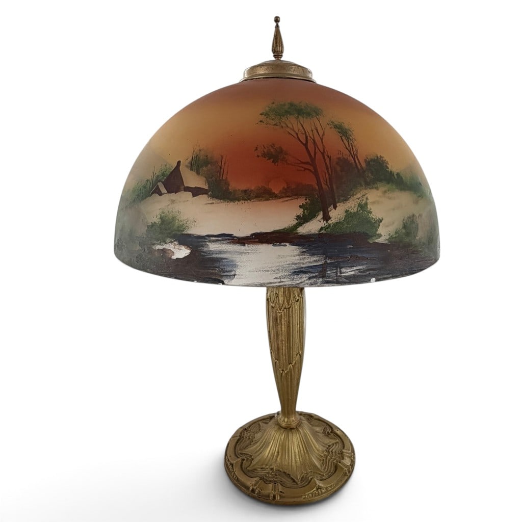 Reverse-Painted Winter Landscape Lamp: Origin: American Date: Circa 1920 Period/Style: Arts and Crafts / Art Deco Maker: Unattributed American manufacture Materials: Reverse-painted glass and gilt-finished cast metal Form: Two-light table