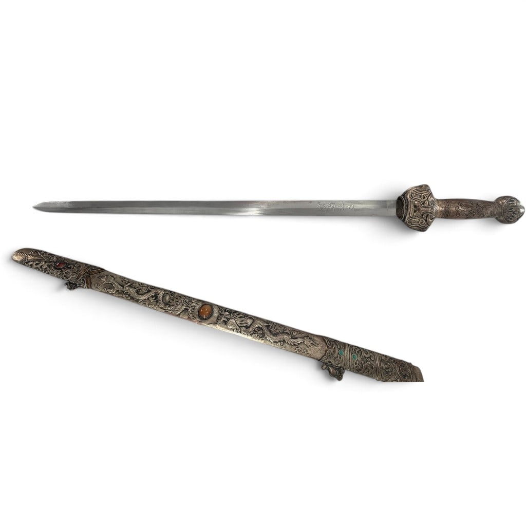 Chinese-Style Silvered Copper Dragon Jian Sword: Origin: China or Sino-Tibetan region Date: 20th century Period/Style: Traditional Chinese / Himalayan Materials: Steel, silvered copper alloy, wood, and colored stone or glass cabochons Form: