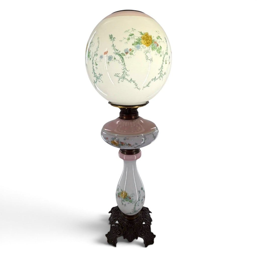 Victorian Floral Glass Parlor Lamp: Origin: American Date: Circa 1900 Period/Style: Victorian Maker: Unattributed American manufacture Materials: Decorated opaque glass, brass, and cast metal Form: Electrified parlor or banquet lamp