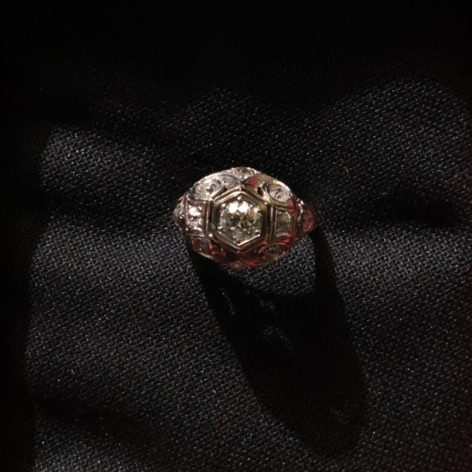 Antique 18K White Gold Diamond Ring: Date: Early 20th century Materials: 18K white gold and diamonds Form: Ring Description: An antique 18K white gold diamond ring centered by an approximately 0.30 to 0.50 carat diamond and accented by