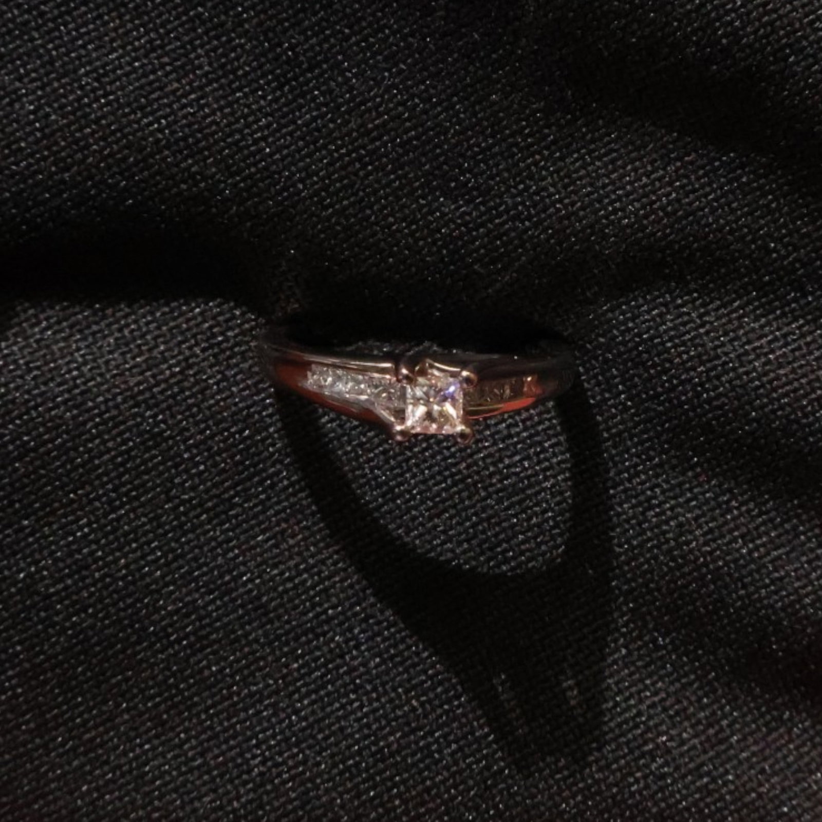 14K Princess-Cut Diamond Ring: Date: Late 20th to early 21st century Materials: 14K white gold and diamonds Form: Ring Description: A 14K white gold ring centered by a princess-cut diamond with additional diamond accents along the