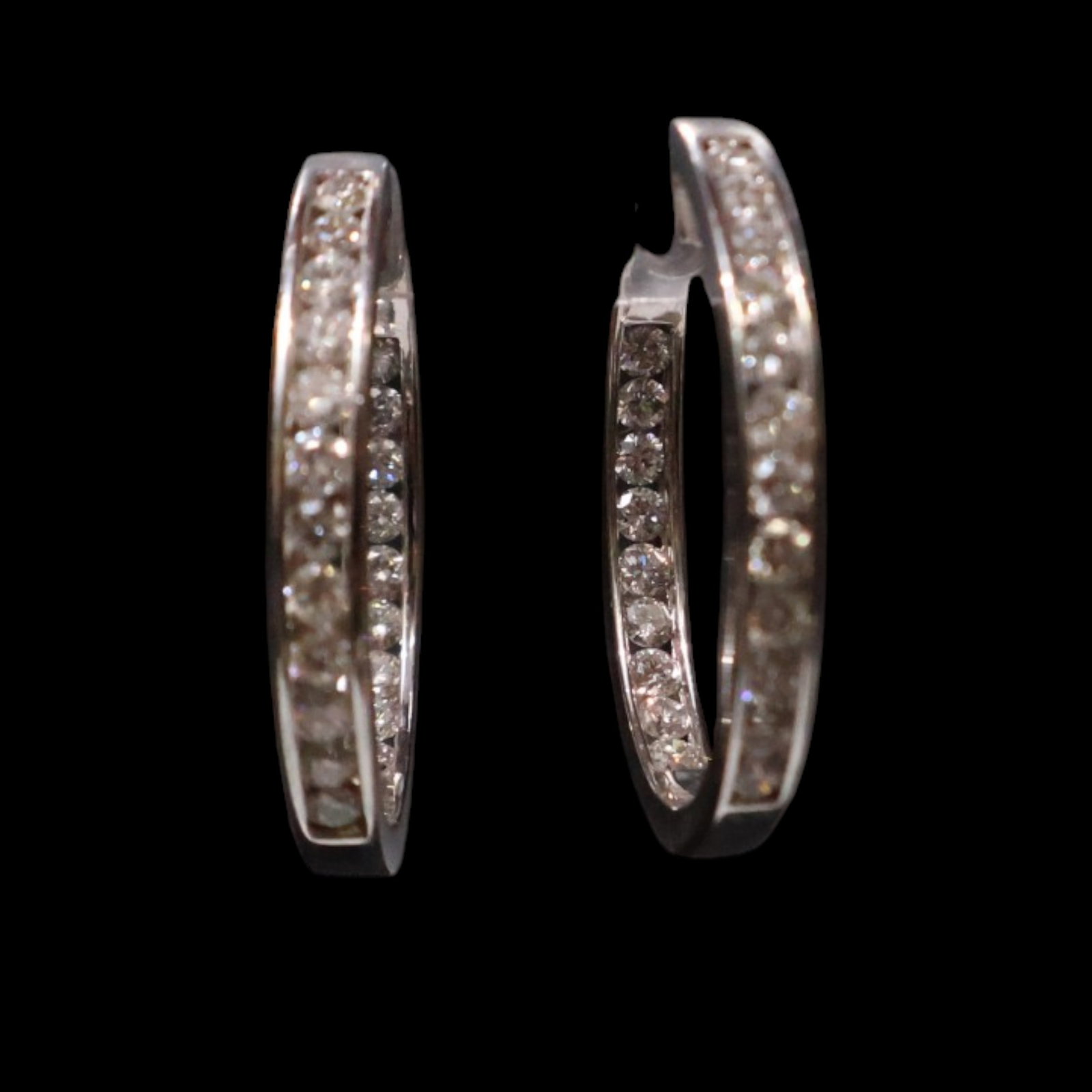 White Gold Diamond Hoop Earrings: Date: Late 20th to early 21st century Materials: White gold and diamonds Form: Pair of hoop earrings Description: A pair of polished white gold hoop earrings set inside and out with rows of round