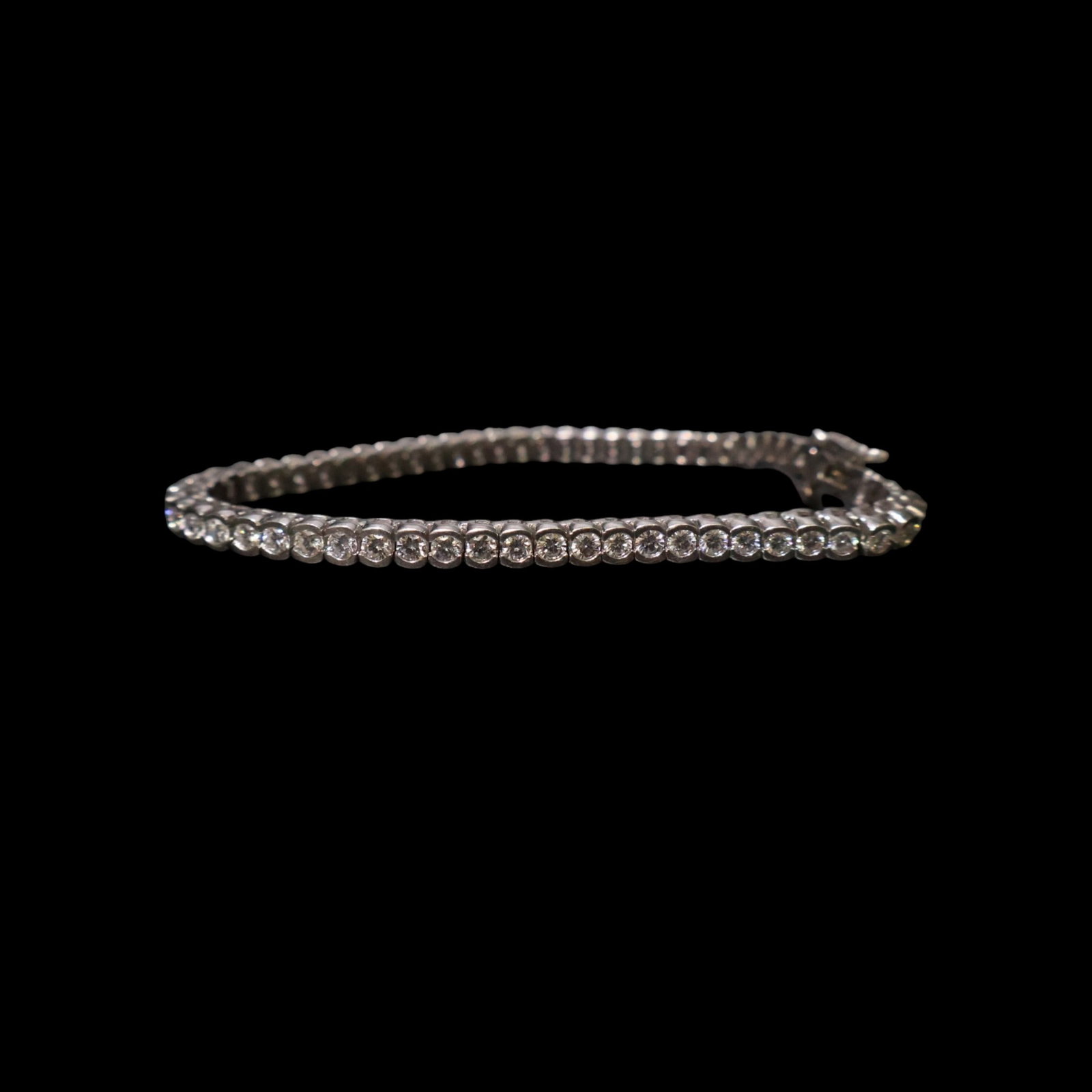 Platinum 4.05 CTW Diamond Tennis Bracelet: Date: Late 20th to early 21st century Materials: Platinum and diamonds Form: Tennis bracelet Description: A platinum tennis bracelet composed of 61 half-bezel-set round brilliant diamonds. The