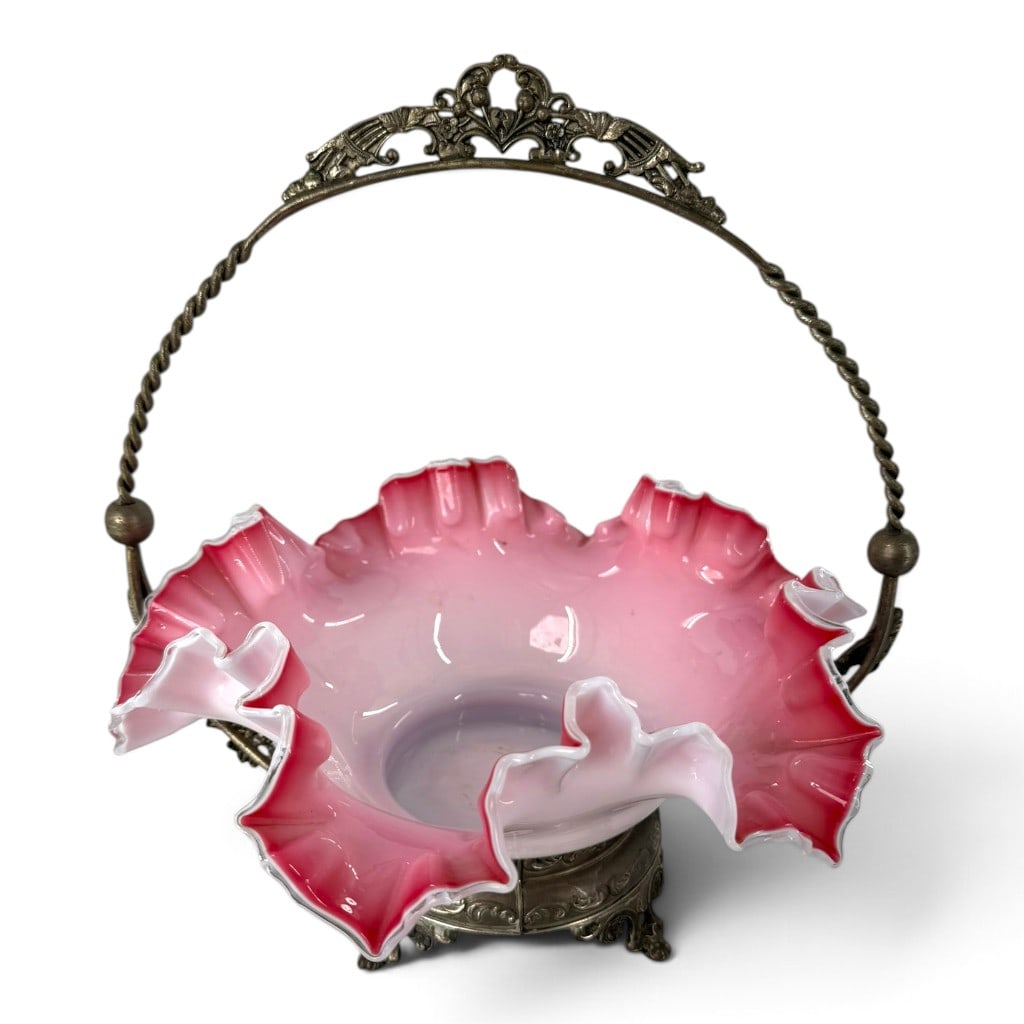 Victorian Cranberry Glass Bride's Basket: Origin: American or Continental Date: Late 19th century Period/Style: Victorian Maker: Unattributed Materials: Blown cased cranberry and opalescent glass with silver-plated metal Form: Bride's basket