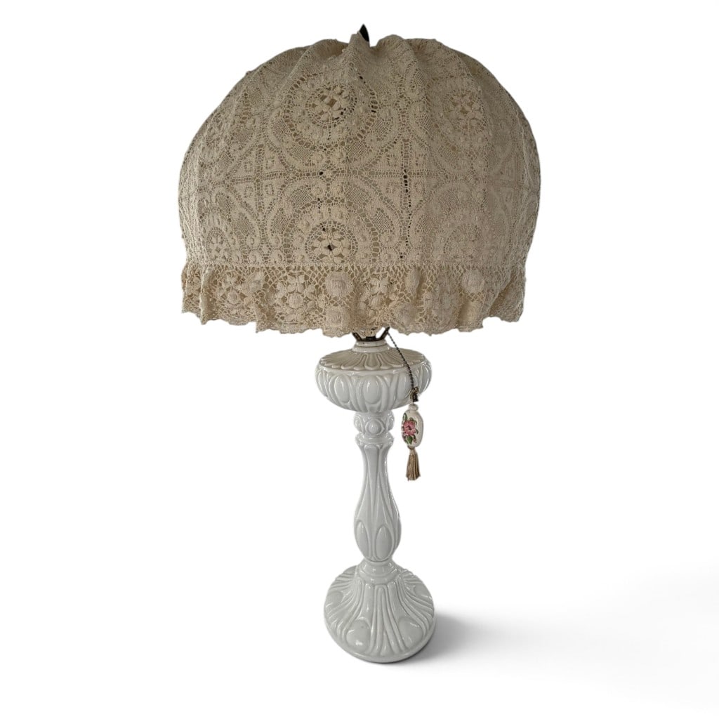 Vintage White Porcelain Lamp with Lace Shade: Origin: American or Continental Date: Mid-20th century Period/Style: Victorian Revival Maker: Unattributed Materials: Glazed porcelain, metal fittings, crocheted cotton lace, and textile Form: