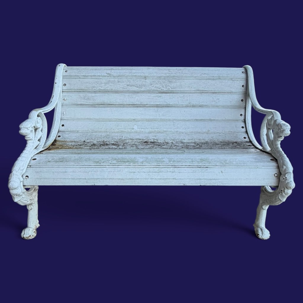 Victorian-Style Dragon Cast Iron Garden Bench: Date: 20th century Period/Style: Victorian Revival Maker: Unidentified Materials: White-painted cast iron and painted slatted seat and back Form: Garden bench Description: A white-painted garden