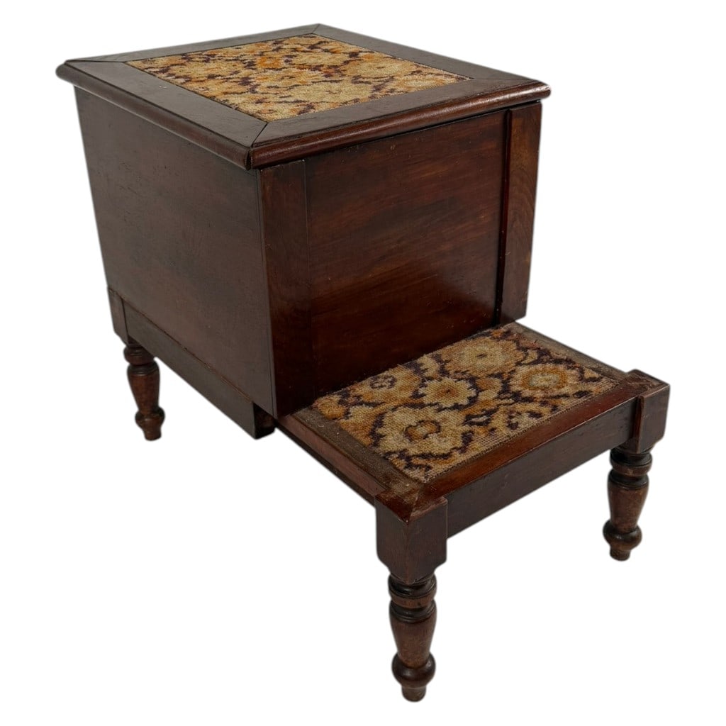 American Victorian Mahogany Chamber Commode: Origin: American Date: Mid-19th century Period/Style: Victorian Maker: Unidentified Materials: Mahogany, ceramic, needlework, textile, and brass Form: Chamber commode with pull-out step Description: