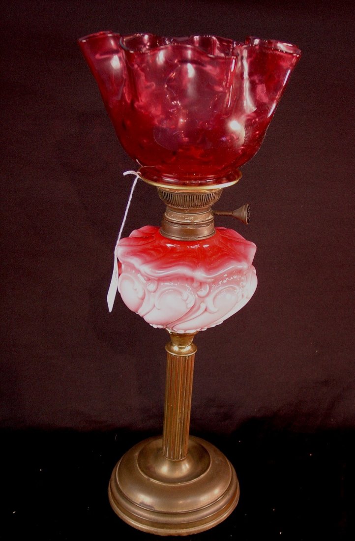 Cranberry opaline glass oil lamp with cranberry: Cranberry opaline glass oil lamp with cranberry shade on brass base, 22in. T.