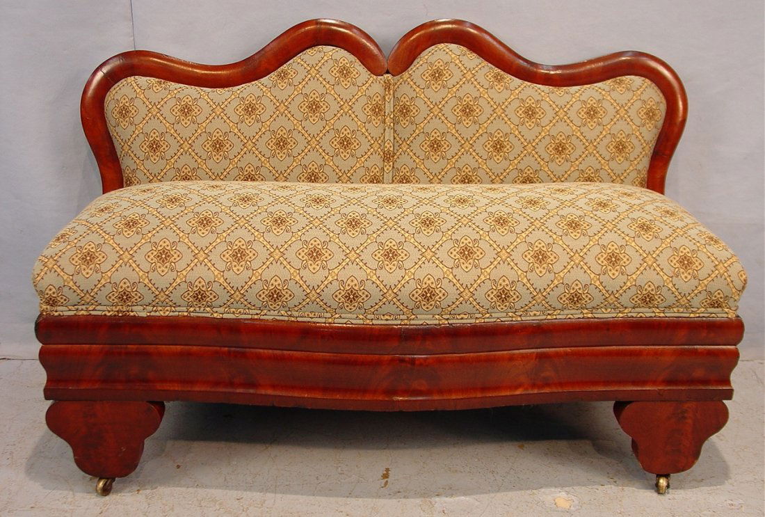 530: Mahogany empire bustle bench with unusual shape: Mahogany empire bustle bench with unusual shape back, pale blue and gold upholstery, ca. 1850, 27in. T, 42in. W, 17in. D.