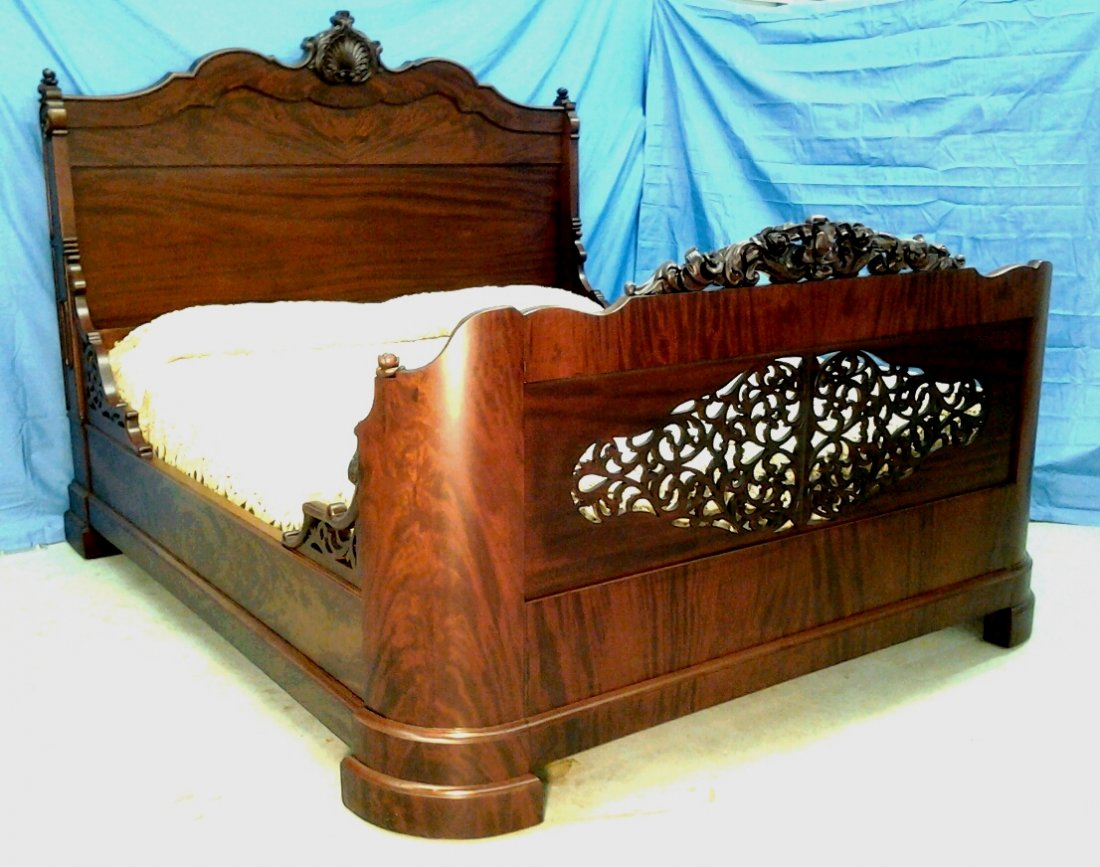 650: Extremely ornate mahogany rococo oversized bed,: Extremely ornate mahogany rococo oversized bed, pierced carved and rounded footboard, 71in. W, 7ft 1in. L, headboard is 62in. T, ca. 1850.