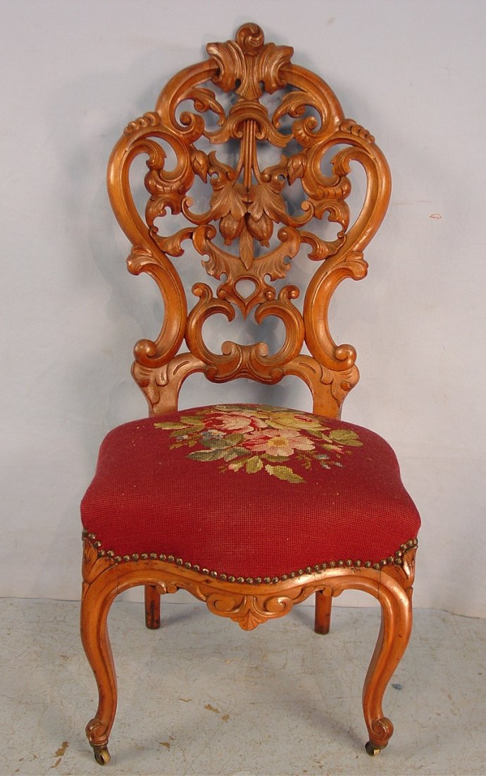 170: Walnut Victorian needlepoint chair, pierced carved: Walnut Victorian needlepoint chair, pierced carved back with maroon colored seat, 41in. T, 18in. W, 17in. D, ca. 1870.