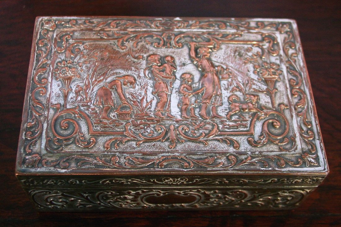 313: Silver over copper dresser box, extremely ornate: Silver over copper dresser box, extremely ornate with children figurines on top, 6IN L, 4IN W, 2IN D