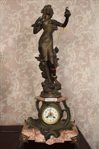 Art Nouveau figural clock of lady: Art Nouveau figural clock of lady with porcelain dial and marble base, marked Aurore Par J. Causse, 33 in. T, 14 in. W, 9 in. D.