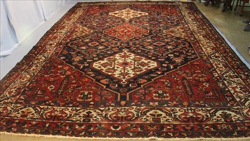 Antique Iranian Rug in dark blue, tan, and burgundy (1 of 5)