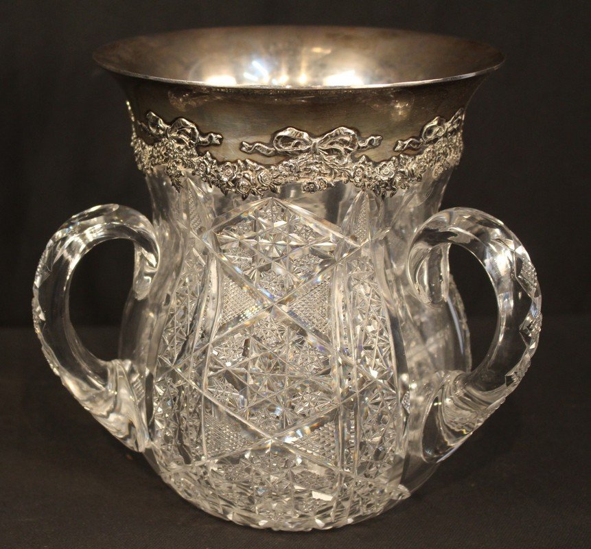 Large cut glass loving cup with sterling rim: Large cut glass loving cup with sterling rim sighned Tiffany, has very small hairline crack on one handle