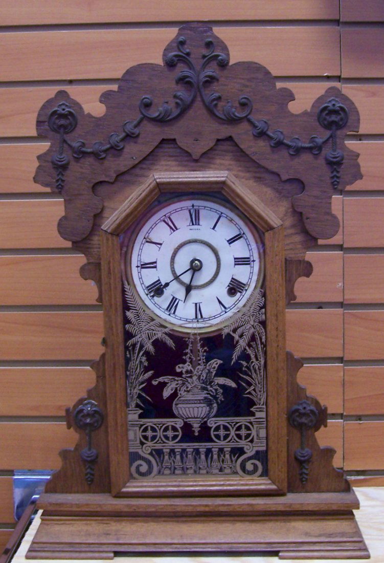 Seth Thomas Kitchen Gingerbread Clock: Beautiful Seth Thomas Kitchen Gingerbread Clock. We believe this was part of the metal series due to the metal decorations on the case. Only six styles of clocks made up this series. 23" Tall, 15" wid