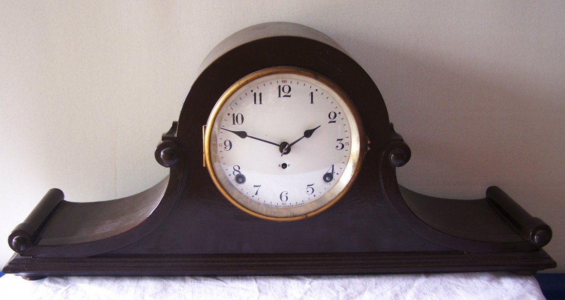 Seth Thomas Tambour Scroll Mantle Clock.: This is a great looking clock. The case has a scroll type appearance and the dial is made of porcelain or enamel. The winding key is included. 9-1/4" tall, 21" wide and 5" deep.