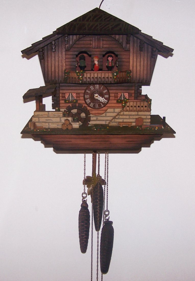 Beautiful 3 weight German Musical Cuckoo Clock: Very Nice West German Made Musical Cuckoo Clock in working condition. The clock cuckoos and plays music. It is in the style of a Chalet with a waterfall and plays the song Edelweiss. It has a swiss mu