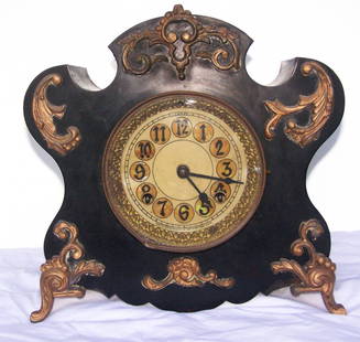 Antique New Haven Clock Company Metal or Cast Iron: Very Ornate metal or cast iron clock made by the New Haven Clock Company in working condition. Very nice dial and ornate gold accents. The clock is 11-1/4" tall x 11-1/2" wide x 5-1/2" deep. A winding