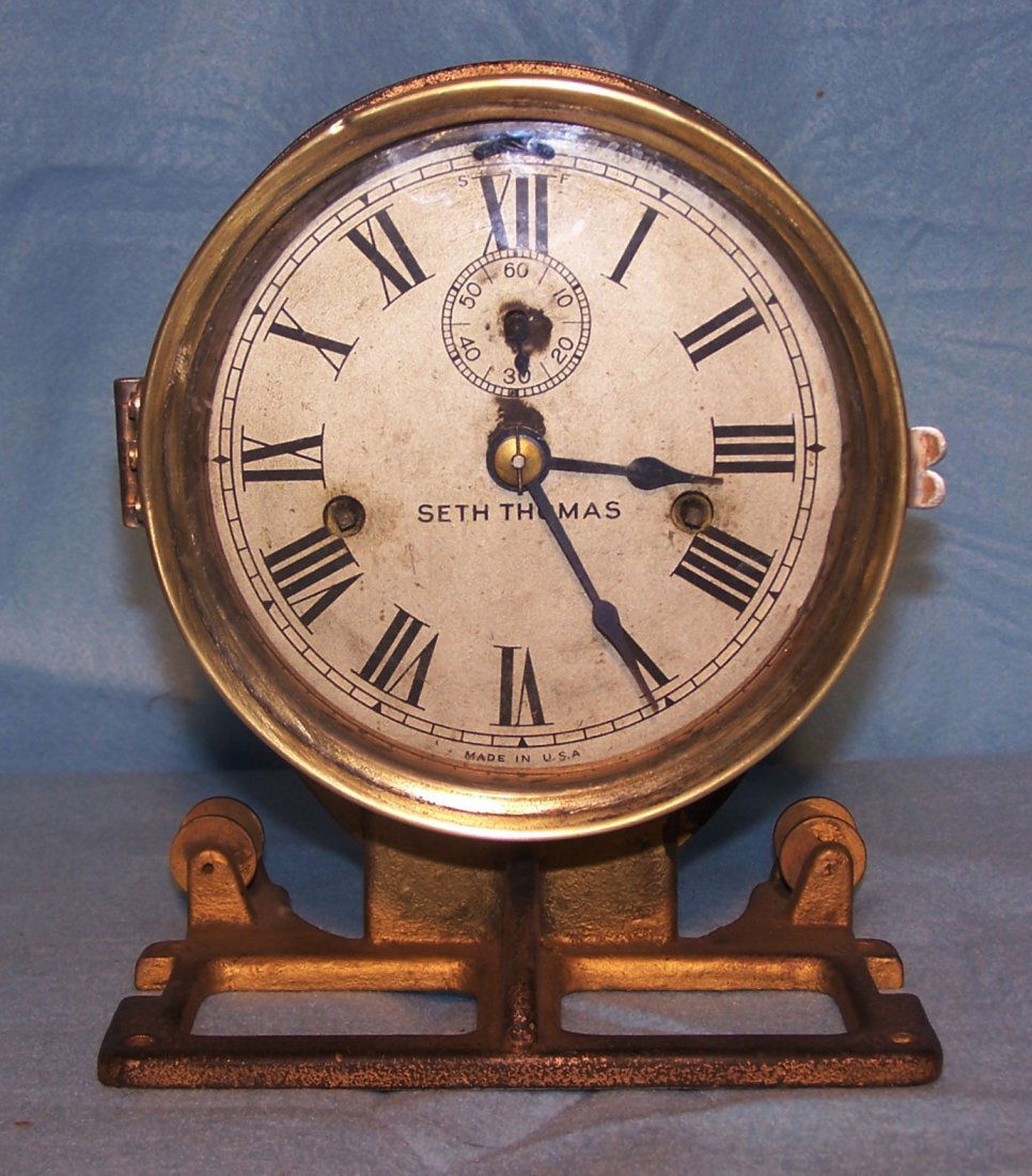 Rare Seth Thomas Ship's Bell Clock: This is a rare Seth Thomas Ship's Bell Clock that is still on the mounting bracket that was mounted to the ship. The clock is in working condition. The dial has roman numerals and a separate sweeping