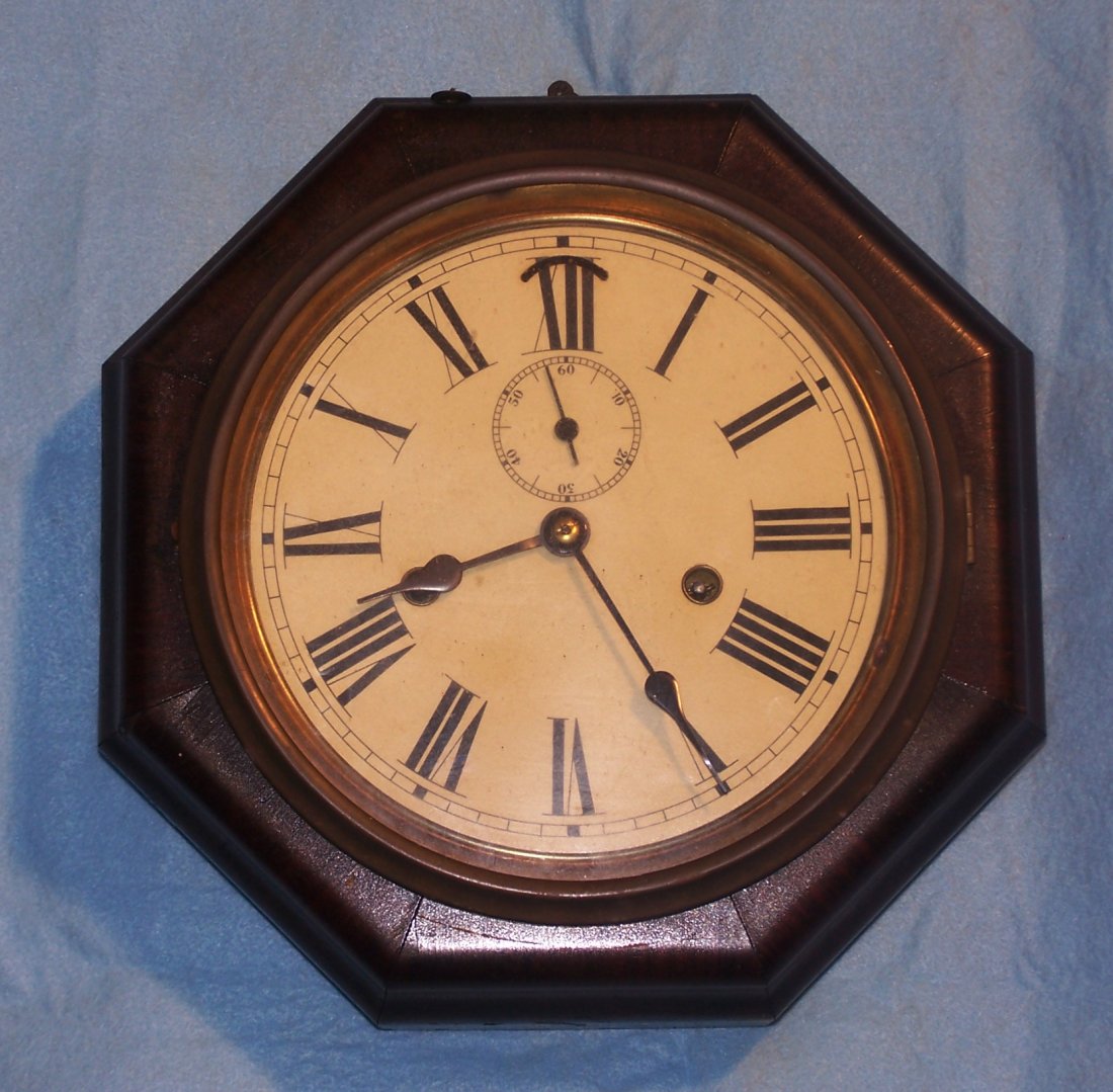Antique E.N. Welch Time and Stike Wall Clock: E.N. Welch Time and Strike Octagon Wall Clock. The name of the clock is Marines. It is an Eight Day and 30 hour clock. It is and 11" Octagon and 4" deep. The winding key is included.