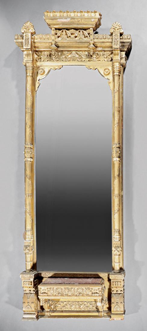 American Renaissance Carved Giltwood Pier Mirror: American Renaissance Carved Giltwood Pier Mirror, 19th c., anthemion carved crest, stepped frieze, vine carved columnar sides, shelf base, block feet, h. 108 3/8 in., w. 40 1/2 in. Note: Losses to ori