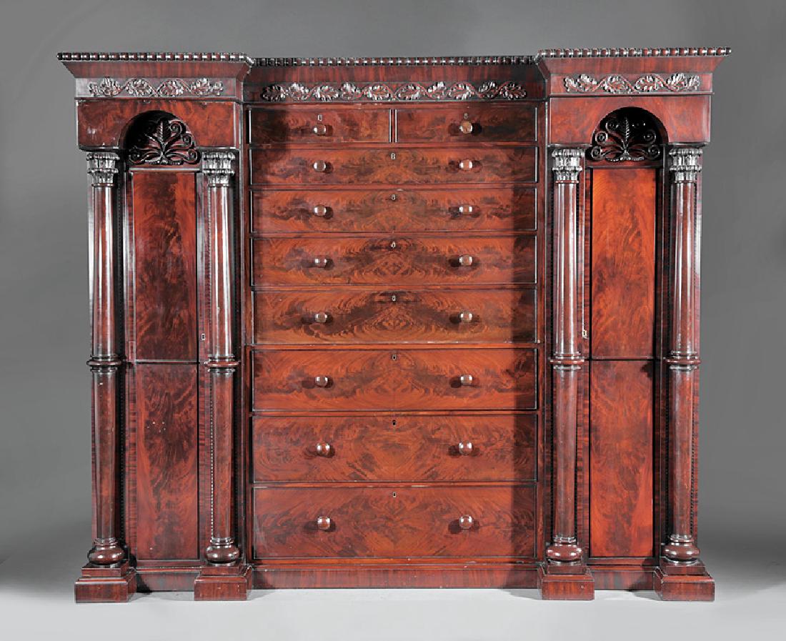 William IV Mahogany Clothes Press: William IV Mahogany Clothes Press, mid-19th c., beaded cornice, foliate frieze, nine drawer center section flanked by a pair of arched anthemion carved single door cabinets with free standing tapered 