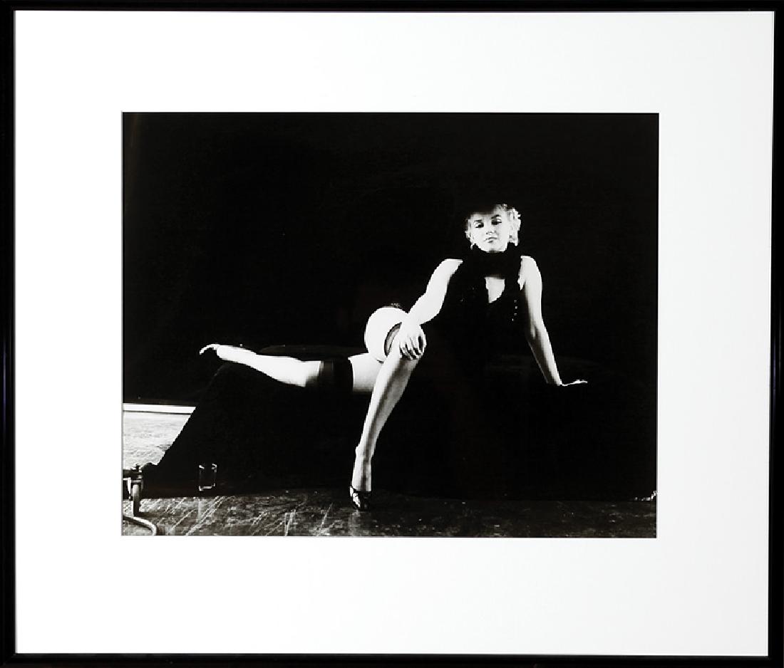 Milton H. Greene (American, 1922-1985): Milton H. Greene (American, 1922-1985), "Marilyn Monroe The Black Sitting (crossed legs and holding knee)", printed 1980, silver gelatin print, signed and dated "8-20-80" and "A Gallery for Fine Photo