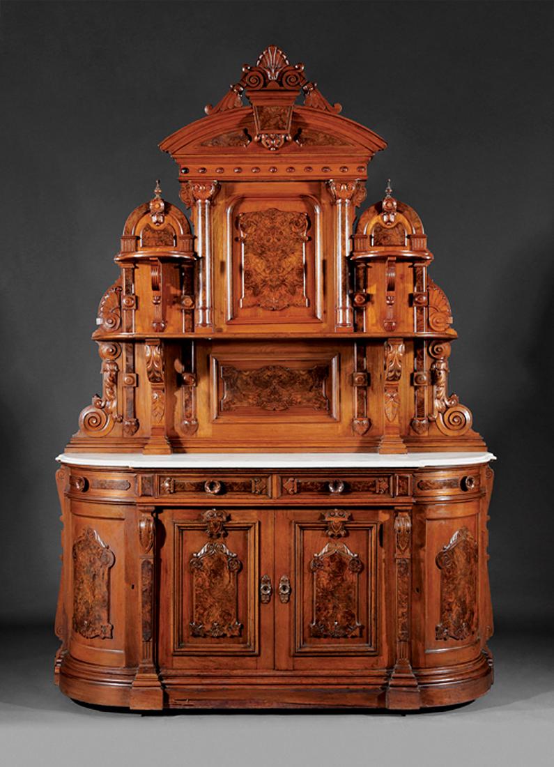 American Renaissance Carved Burled Walnut Sideboard: American Renaissance Carved and Burled Walnut Sideboard, late 19th c., anthemion crest, blocked frieze, paneled back with shelves, bowfront marble top, conforming case with frieze drawers over paneled