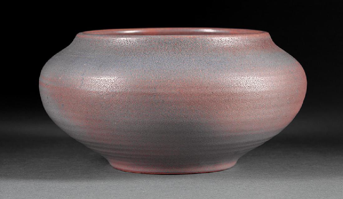 Newcomb College Art Pottery Low Bowl: Newcomb College Art Pottery Low Bowl, c. 1910-1915, matte glaze with blue and mauve modulating underglaze, base marked with Newcomb cipher, Joseph Meyer's potter's mark, h. 6 in., dia. 10 in. Note: Si