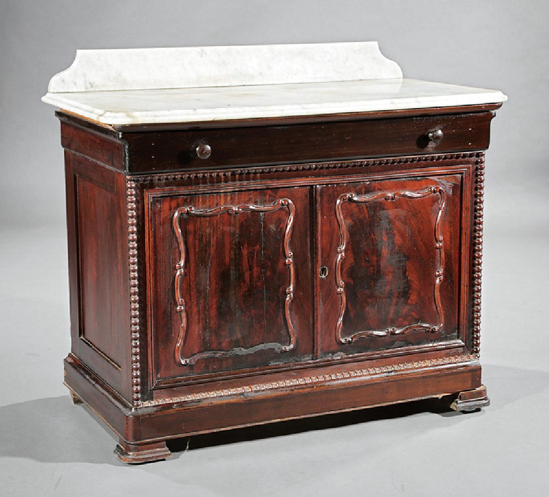 American Rococo Carved Mahogany Washstand: American Rococo Carved Mahogany Washstand, mid-19th c., probably New Orleans, marble top with backsplash, long drawer, two paneled doors, beaded moldings, blocked feet, h. 35 in., w. 41 in., d. 20 1/2