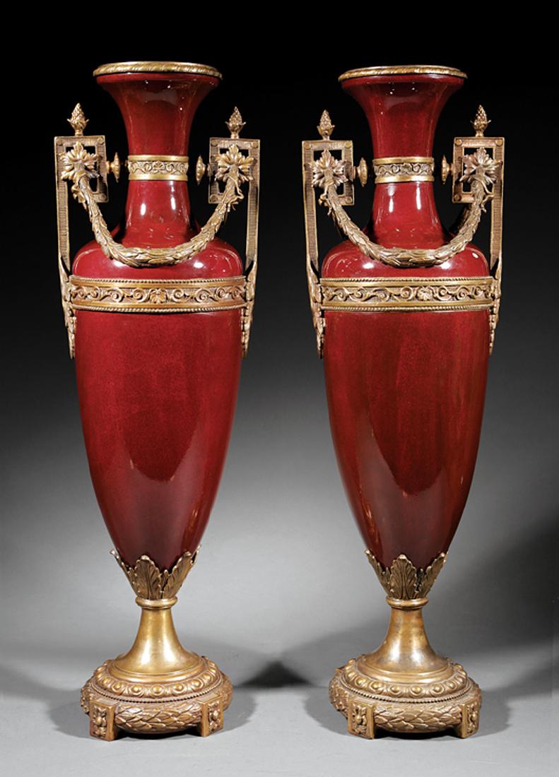 Bronze-Mounted Sang de Boeuf Porcelain Vasee: French Bronze-Mounted Sang de Boeuf Porcelain Vases in the Neoclassical Taste, 20th c., Greek key handles, laurel swags, h. 29 in., w. 9 in., d. 7 in
