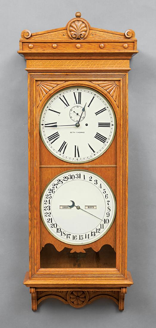 Seth Thomas Oak Office Calendar No. 13 Clock: Seth Thomas Oak Office Calendar No. 13 Clock, c. 1885, 12-inch dial marked "SETH THOMAS, Manufactured in the United States of America", sweep second hand, h. 49 in., w. 18 1/2 in., d. 7 1/2 in Ref.: L