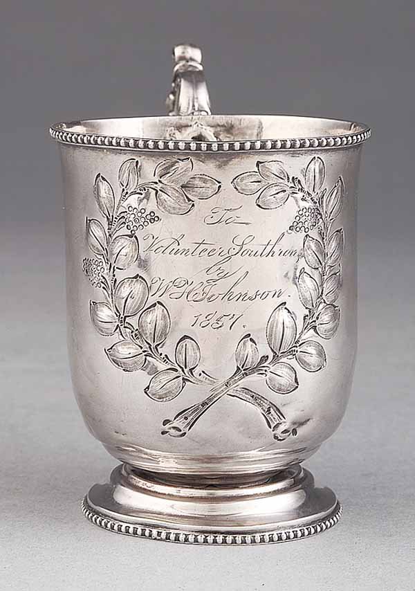 American Coin Silver Presentation Cup: An American Coin Silver Presentation Cup , with pseudo-hallmarks, c. 1850, inscribed "To Volunteer Southron by WH Johnson 1857", with repousse branches enclosing inscription, scroll handle and beaded
