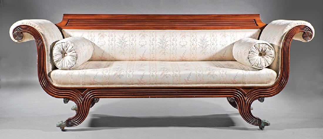 West Indies Carved Mahogany Sofa: West Indies Carved Mahogany Sofa, 19th c., Barbados, shaped crest with inset reeded panel, scrolled reeded arms, conforming seat rail, saber legs, brass paw feet, casters, h. 34 3/4 in., w. 89 in., d.