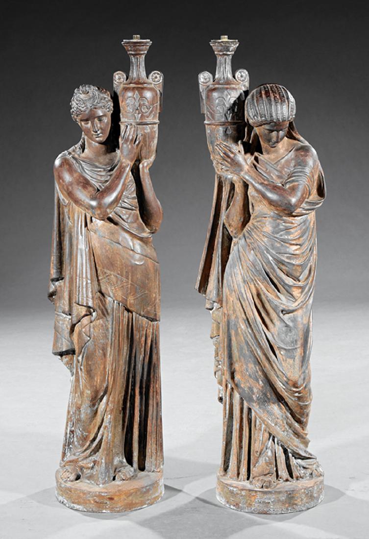 Napoleon III Patinated Cast Iron Torcheres: Pair of Napoleon III Patinated Cast Iron Figural Torcheres, 19th c., foundry mark "Val d'Osne", Classical maidens holding volute-handled vases, h. 45 1/4 in., w. 11 1/2 in., d. 10 in